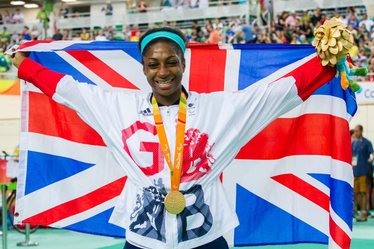 Woman with British flag and medal around her neck