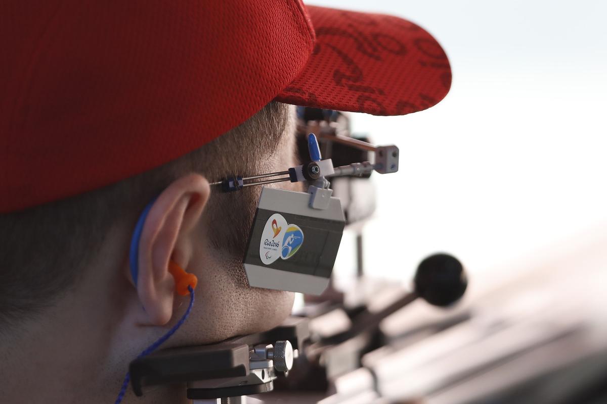 a male Para shooter takes a shot