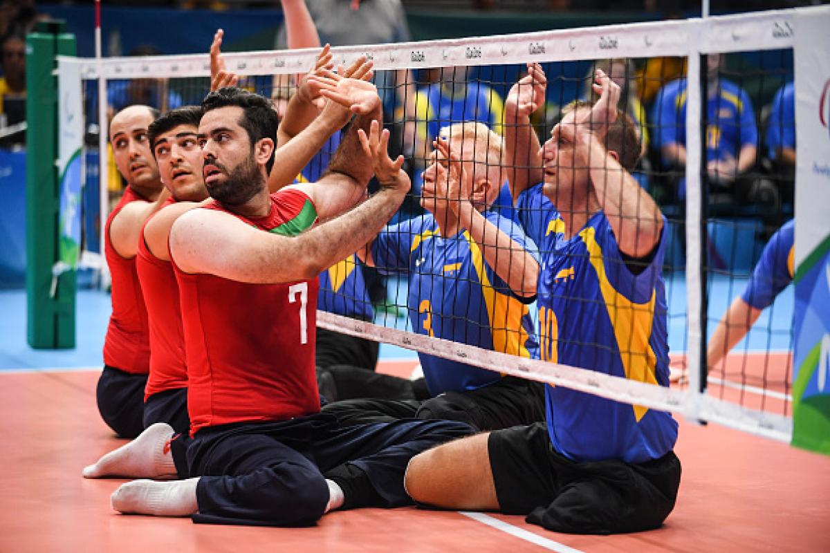 Sadegh Bigdeli of Iran, Petro Ostrynskyi and Sergii Shevchenko of Ukraine compete during Mens Sitting Volleyball match between Iran and Ukraine at the Rio 2016 Paralympic Games.