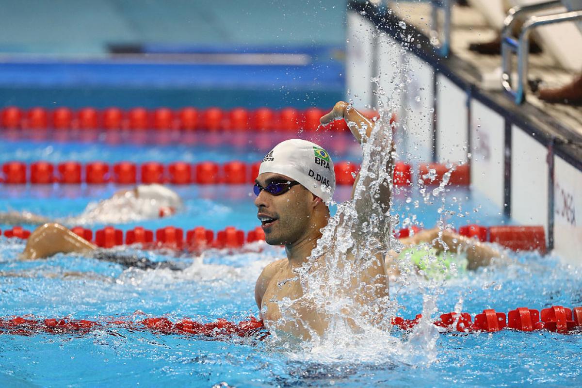 A swimmer celebrates winning gold