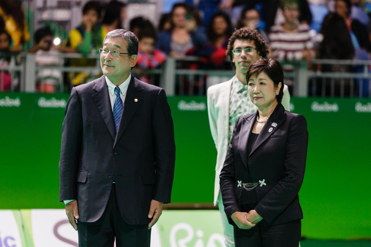 Yuriko Koike two officials stand together at a medal ceremony