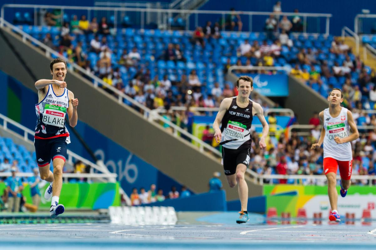 three runners sprint for the line