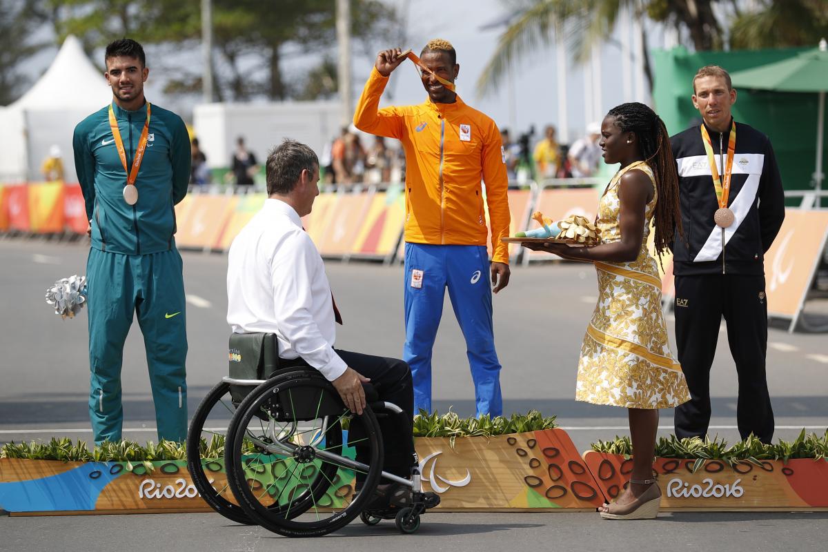 three men on a podium