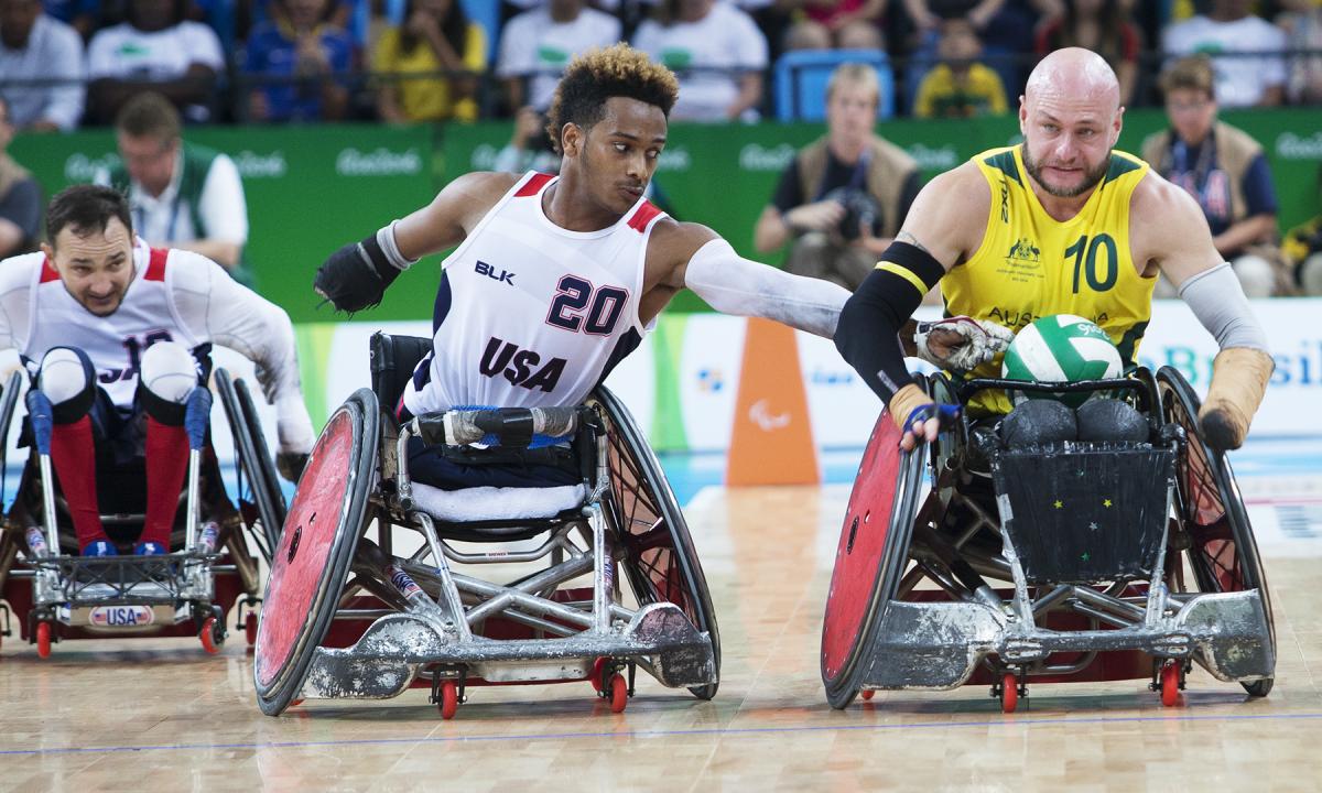 Australia's Chris Bond pushes down the court as USA's Josh Brewer reaches for the ball