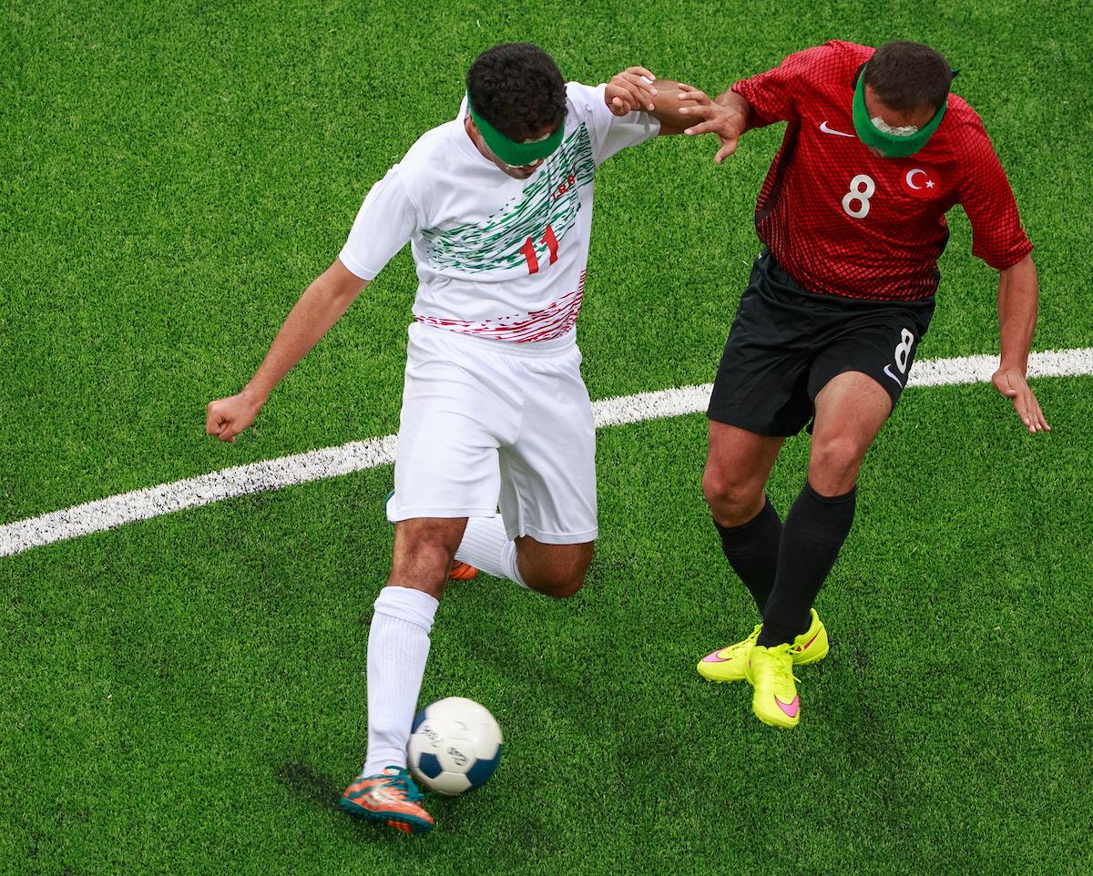 Two blind footballers fighting for the ball