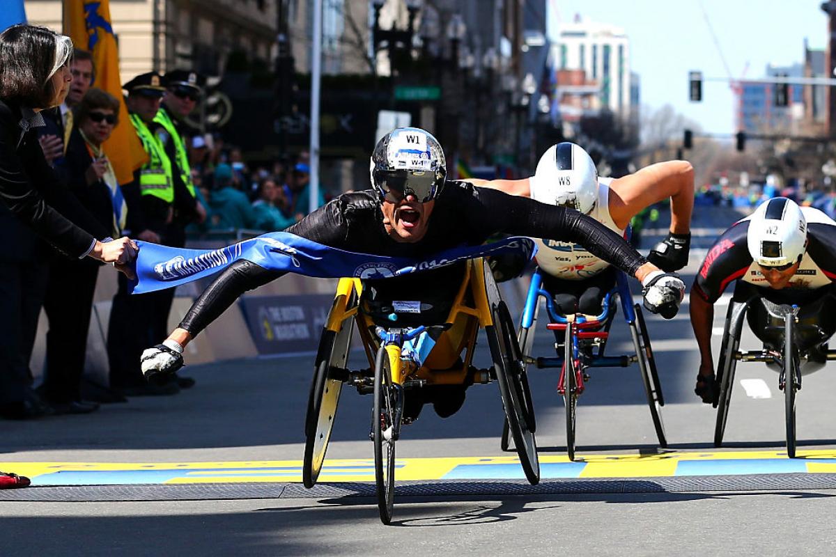 Marcel Hug of Switzerland crosses the finish line to win the men's push rim wheelchair race during the 120th Boston Marathon on April 18, 2016 in Boston.