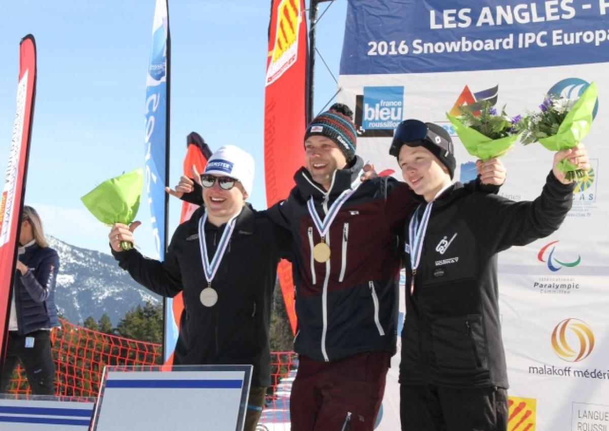 Three men on a podium