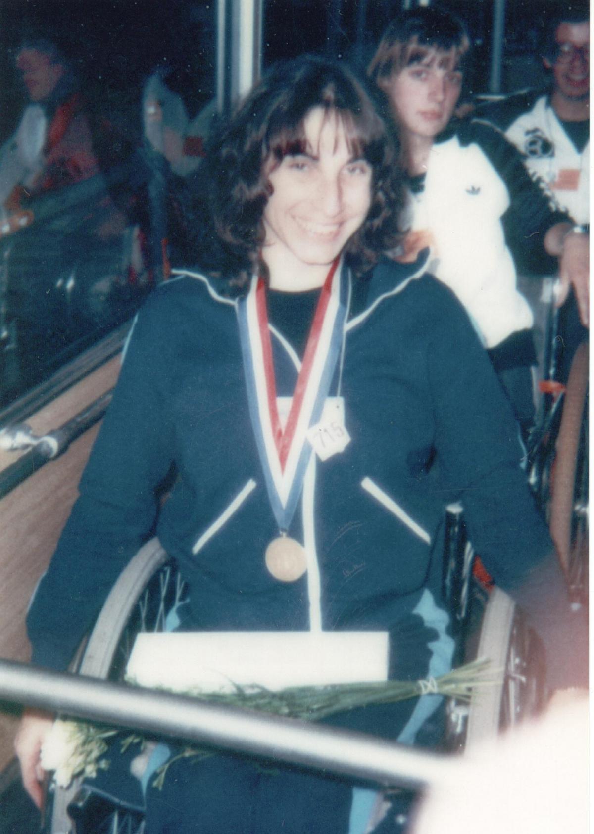 Marcela Rizzotto - Argentina Photo of a woman in a wheelchair with a medal around her neck. The photo looks very old