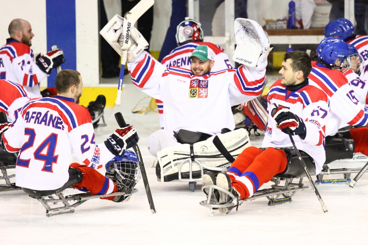 Para ice hockey players celebrate their gold medal win