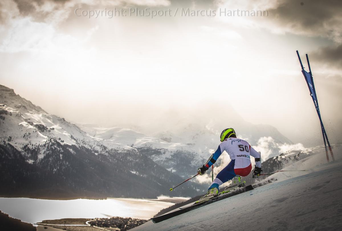 Alpine skiing World Cup - St. Moritz A standing alpine skiier goes down a slope with mountainous backdrop