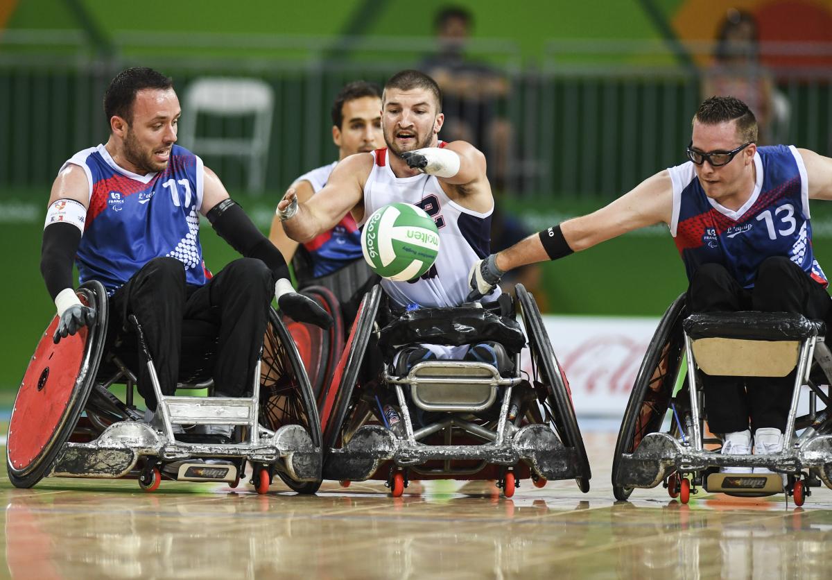 Kory Puderbaugh of United States and Christophe Salegui and Jonathan Hivernat of France compete during the Wheelchair Rugby match between United States and France