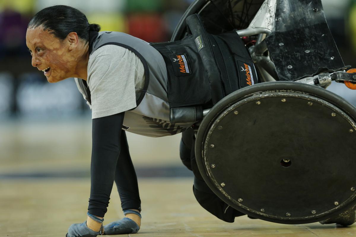 Maia Amai of New Zealand (probably the strongest female player in the game) smiles after being knocked over during a match