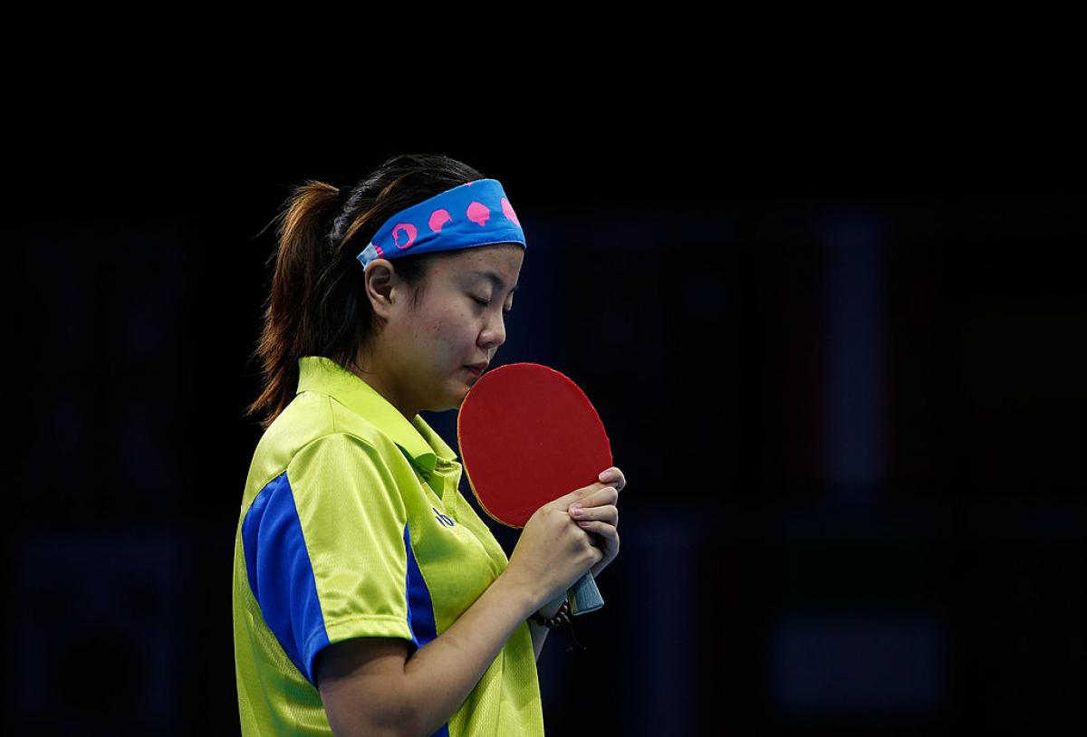 Chinese table tennis player kissing her racket.