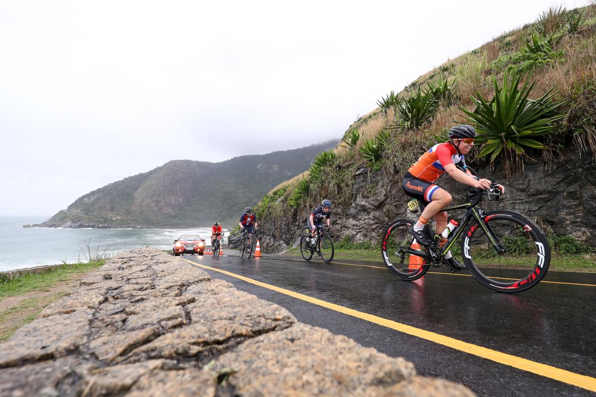 A group of cyclists climbing up a hill in a road race