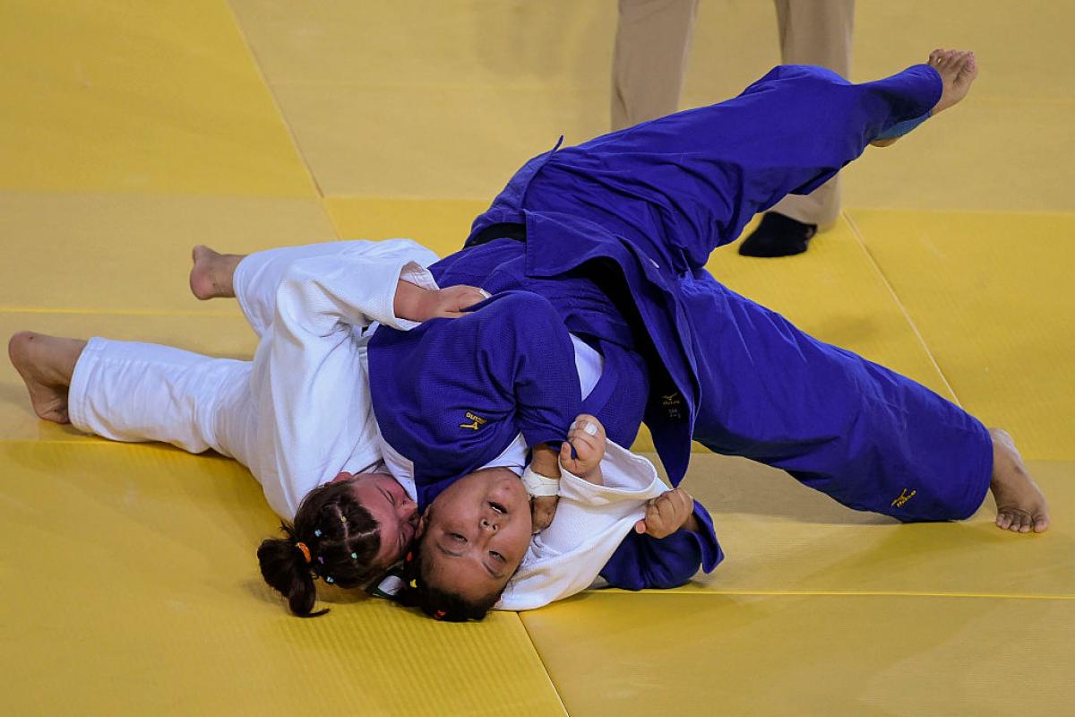 Yanping Yuan (blue) of China with Alimova Khayitjon of Uzbekistan during the Women +70 kg Judo Gold Medal match on Day 3 of the Rio 2016 Paralympic Games