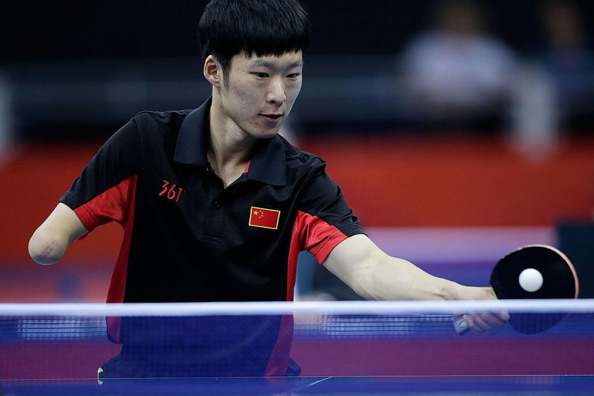 Yang Ge Yang Ge of China returns serve against Sebastian Powrozniak of Poland during the final of the Men's Team Table Tennis - Class 9-10 London 2012