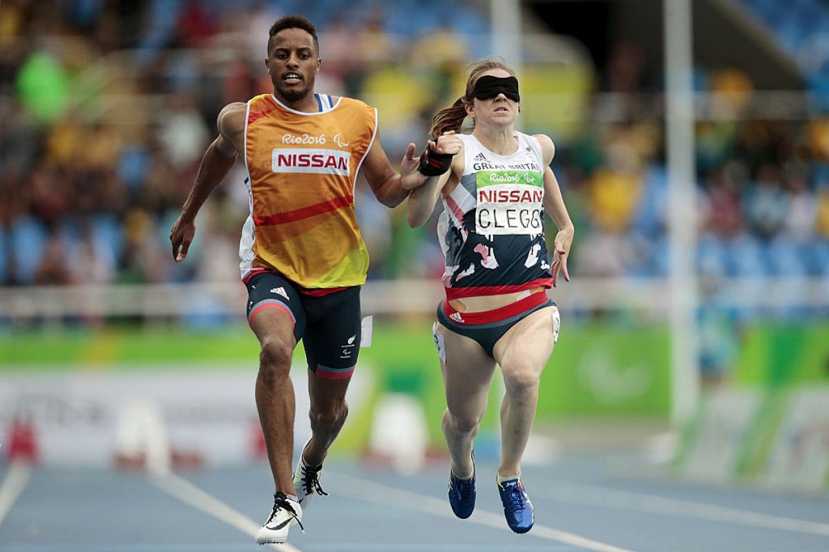 Chris Clarke and Libby Clegg of Great Britain in action during the women's 100m - T11 Semifinals at the Olympic Stadium on Day 2 of the Rio 2016 Paralympic Games