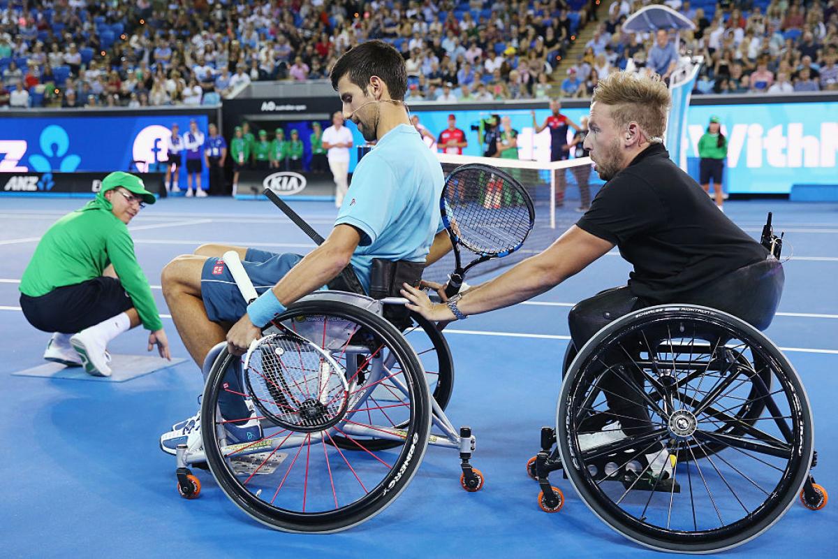 Novak Djokovic, Dylan Alcott - charity Margaret Court Arena in Melbourne Two men in wheelchairs on a tennis court