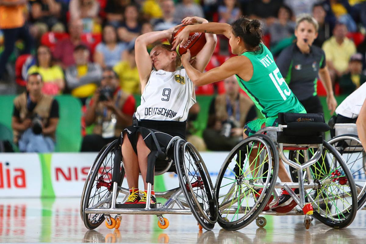 female wheelchair basketball player Laura Fuerst fighting with another player for the ball