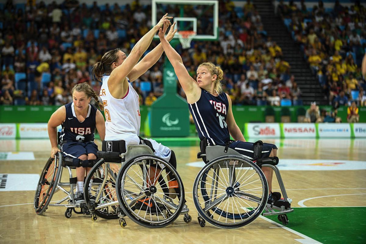 Female wheelchair basketball player Mariska Beijer fighting with another player for the ball 