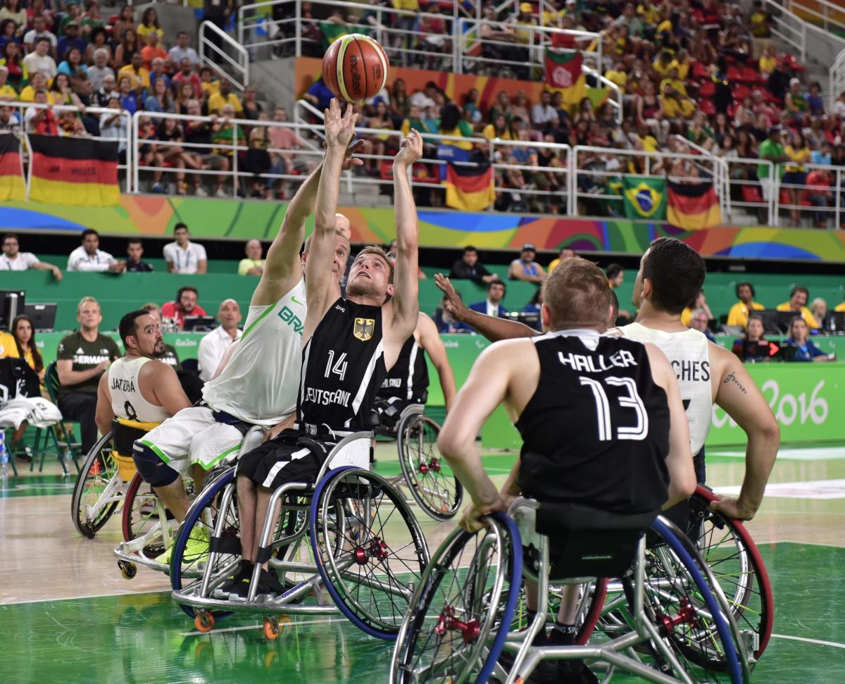 male wheelchair basketballer Thomas Boehme challenging for the ball