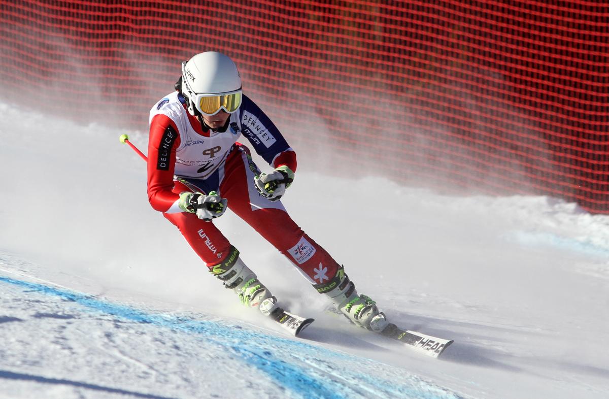 a female Para skier heads down slope