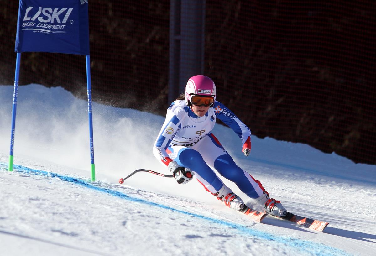 a female Para skier rounds a gate