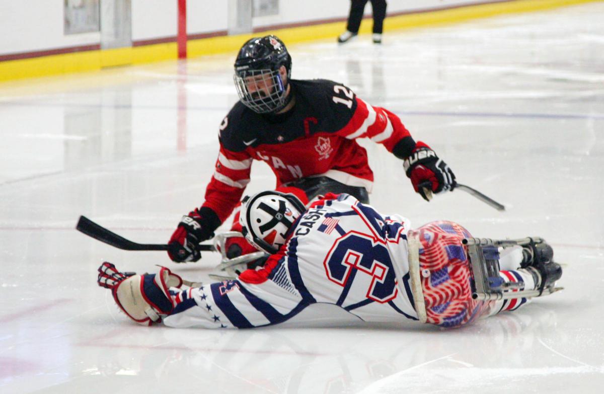 Steve Cash making a save against Greg Westlake in the gold medal game USA v Canada at the 2015 IPC Ice Sledge Hockey World Championships A-Pool in Buffalo, USA.