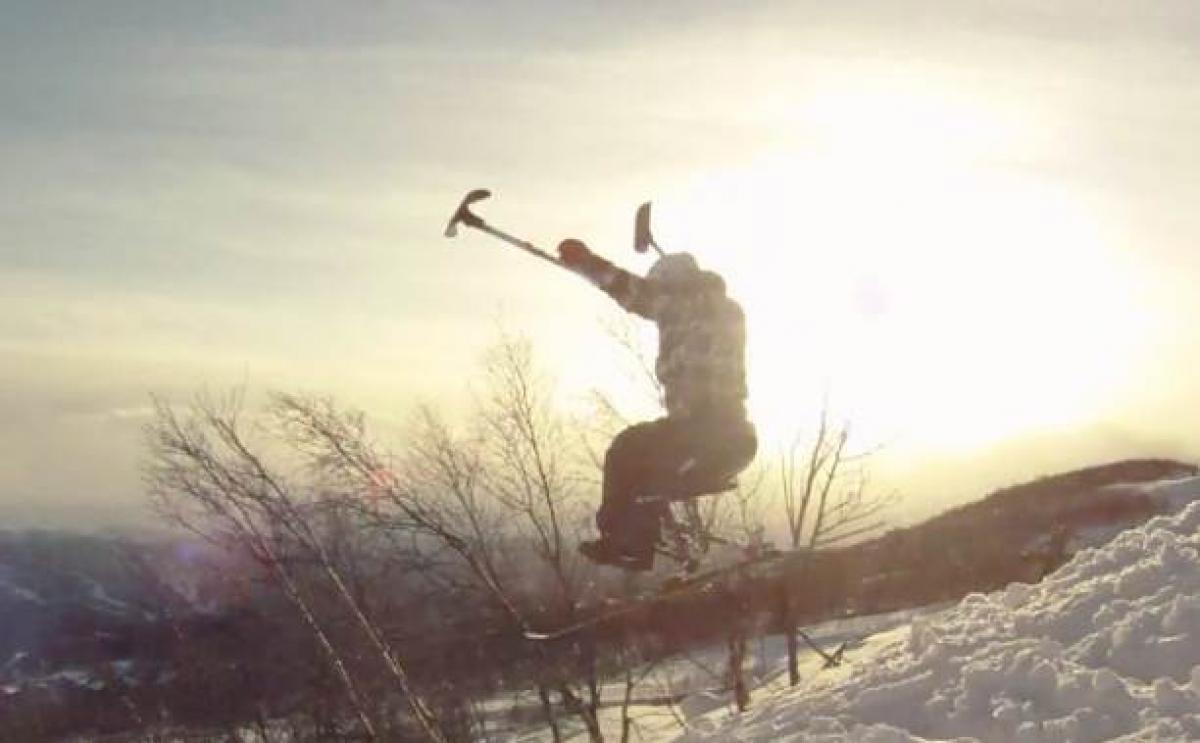 A picture of a man in a sledge skiing