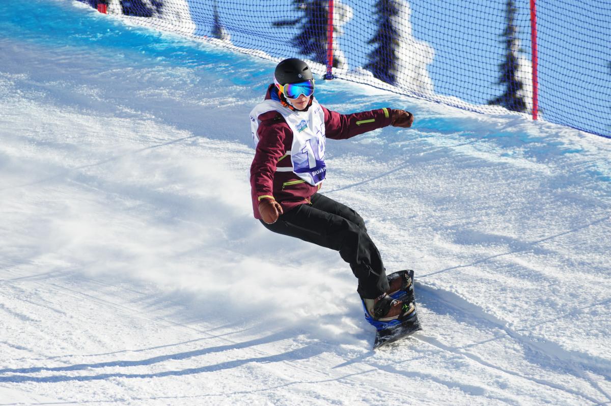 Woman on snowboard turns on a banked turn