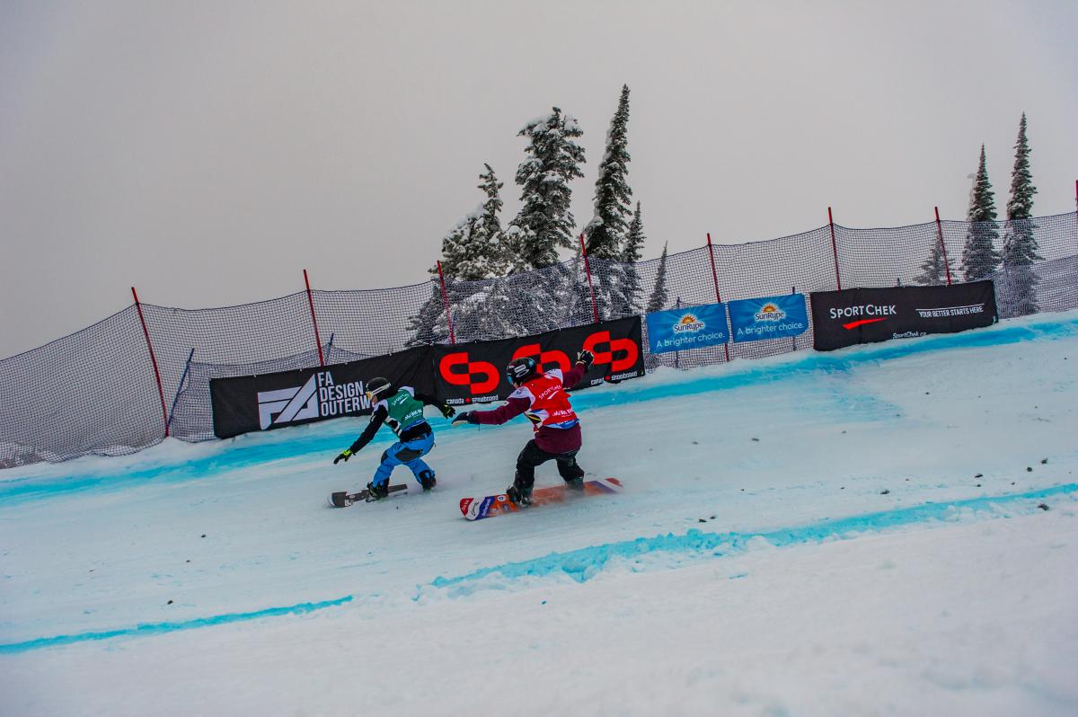 Two men on snowboards race