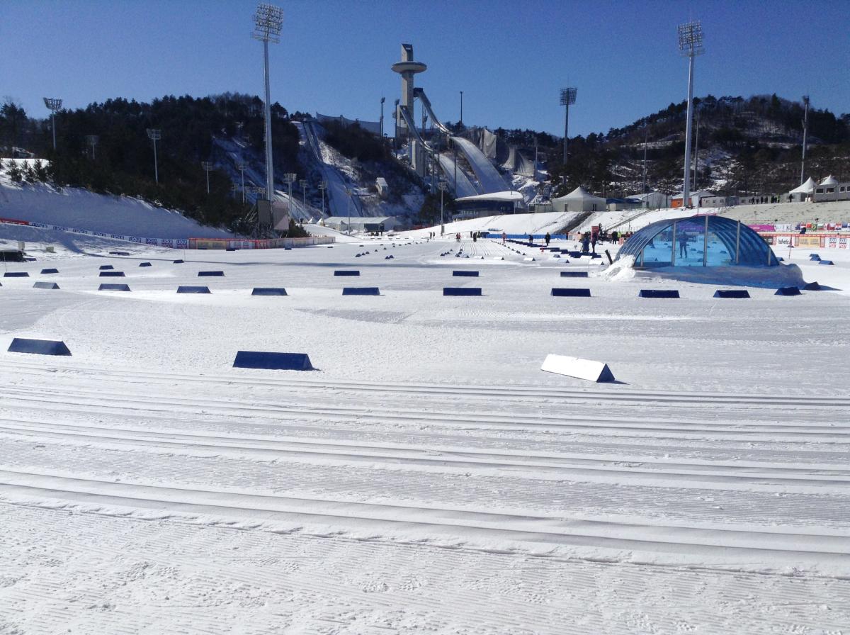 Alpensia Biathlon Centre - PyeongChang 2018 Paralympic Winter Games View on a snowy cross-country venue with a ski jump in the background