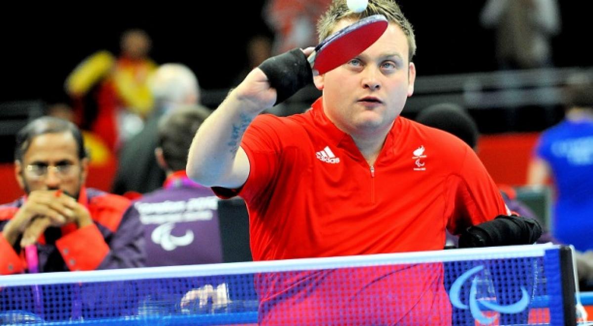 Robert Davies Upper body of man playing table tennis