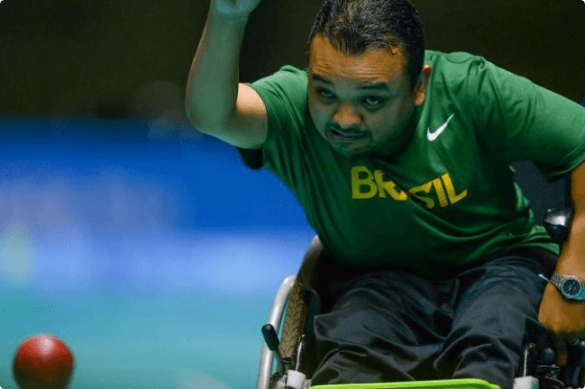 Man in wheelchair throwing a boccia ball