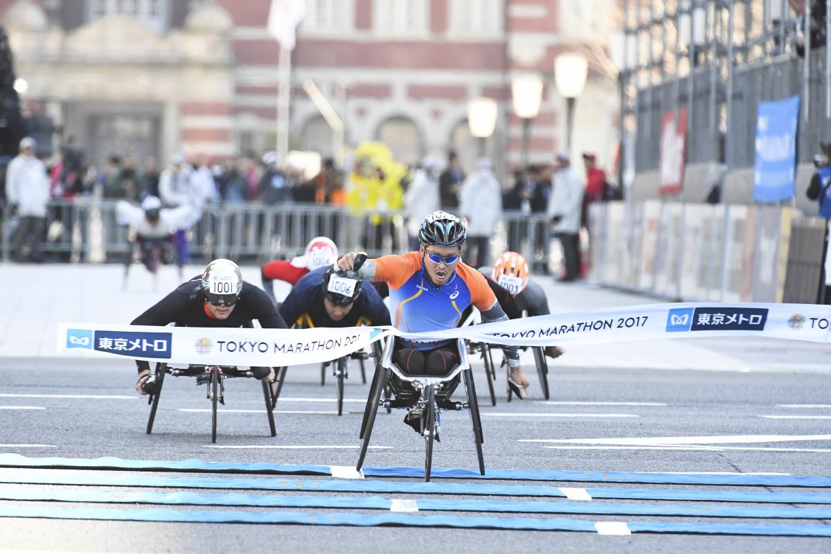 Japan's Sho Watanabe crosses the line to take the 2017 Tokyo marathon ahead of Switzerland's Marcel Hug.