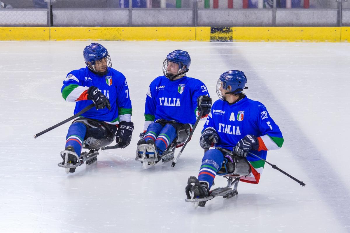 Torino Para Ice Hockey International Tournament - Team Italy Three Para ice hockey players on ice talking to each other