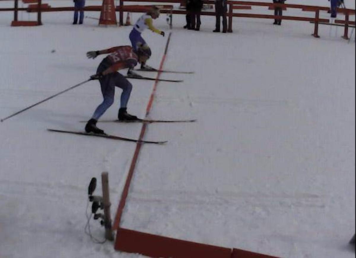 Two women's standing skiers cross the line at exactly the same time