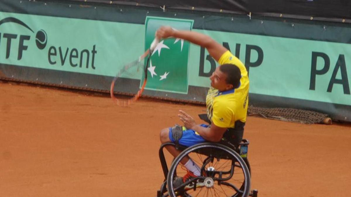 Man in wheelchair playing tennis