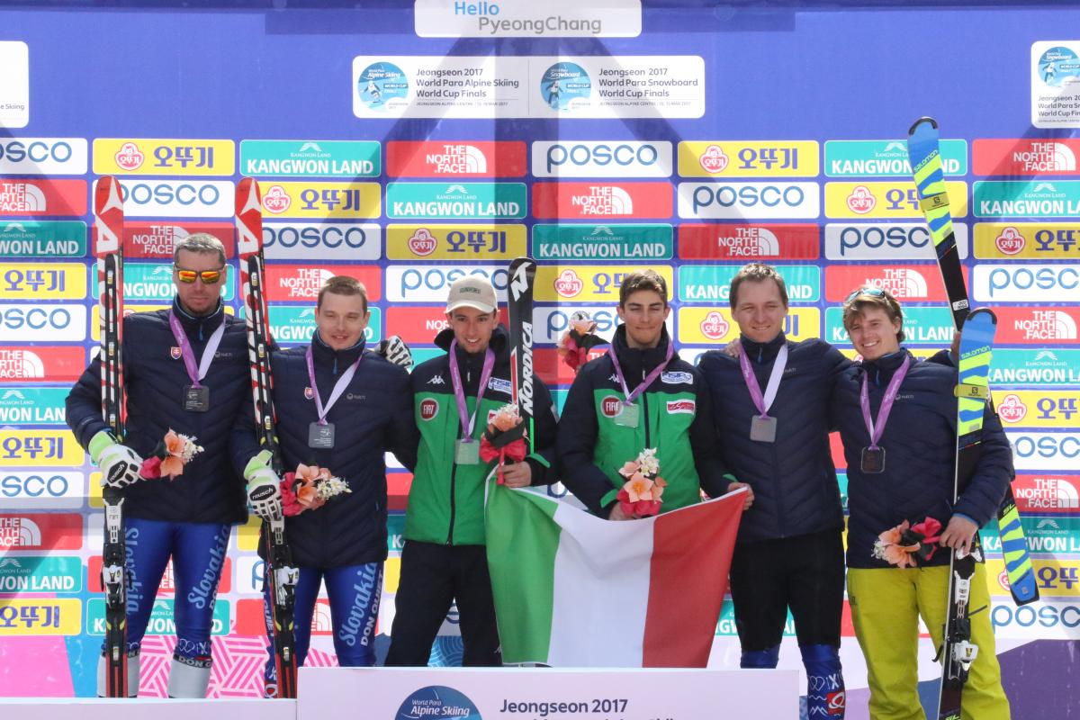 Six skiers on a podium