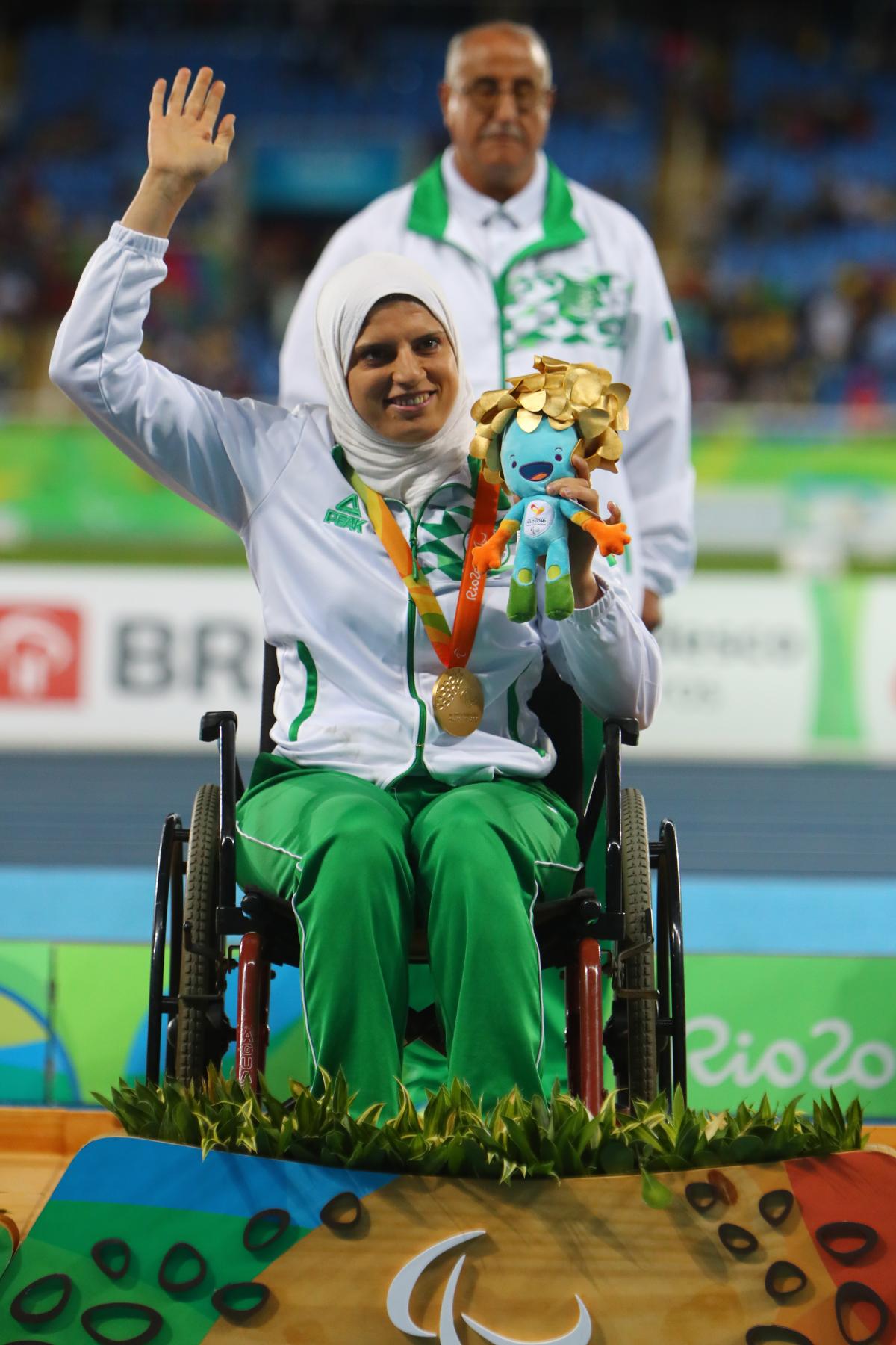 Gold medalist Asmahan Boudjadar of Algeria poses on the podium at the medal ceremony for women's shot put at Rio 2016.