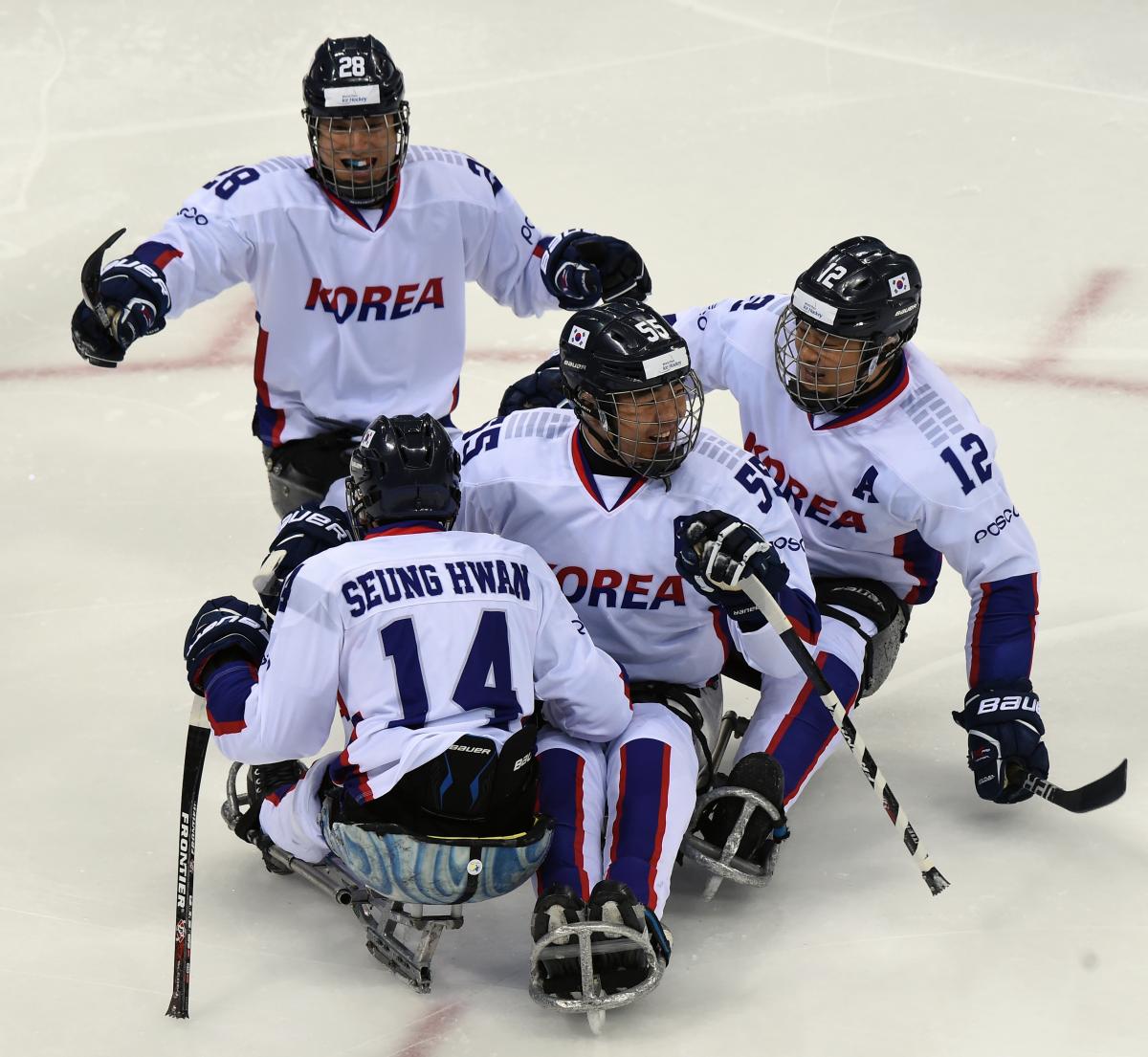Para ice hockey players celebrate victory