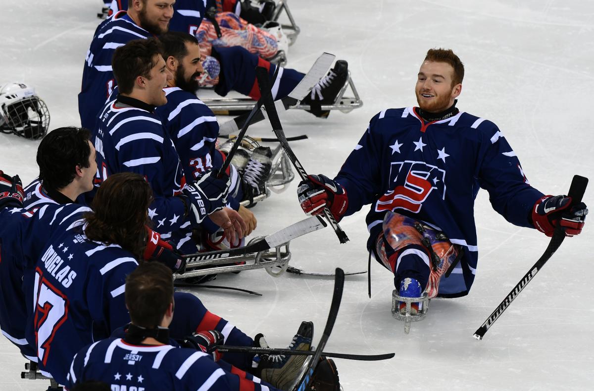 USA Declan Farmer stick tapping Brody Roybal - Gangneung 2017 Two Para ice hockey players smile after a game