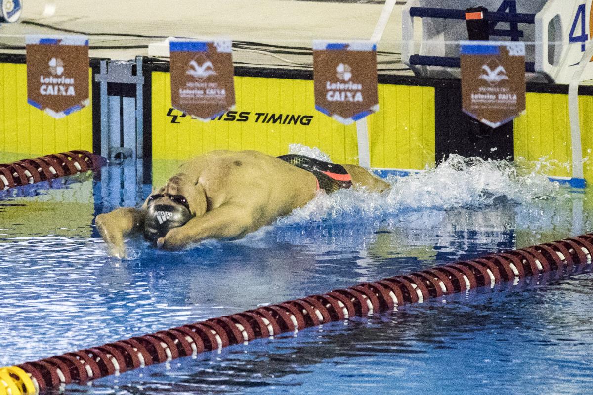 A swimmer with limb impairments starts his race