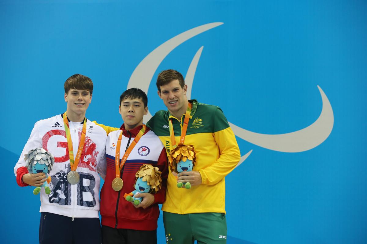 Three male swimmers standing on a podium at Rio 2016