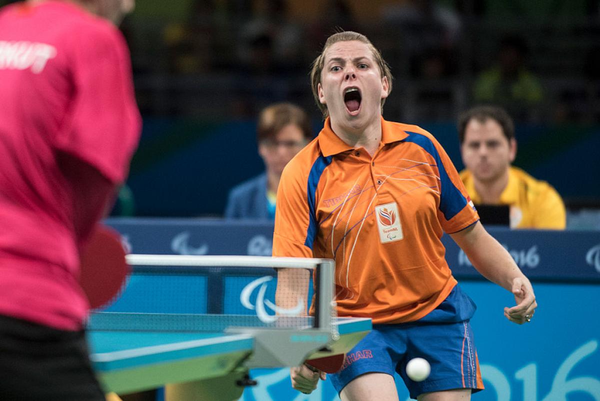 Female table tennis player celebrates after a point