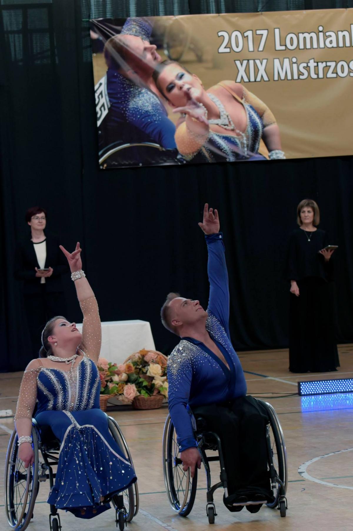 Man and woman in wheelchairs dance