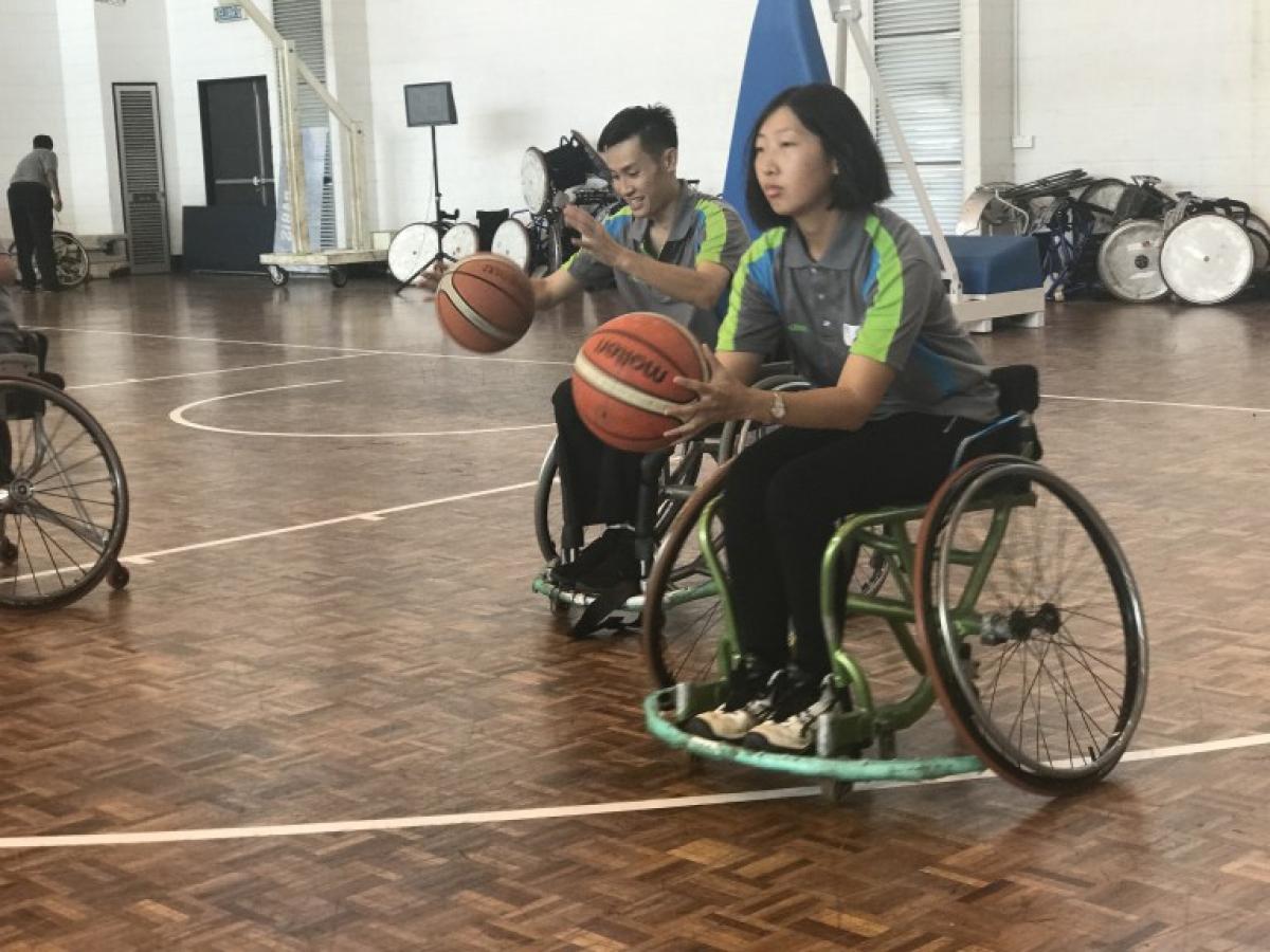 Officials clinic in Malaysia - wheelchair basketball Woman in wheelchair shooting a basketball