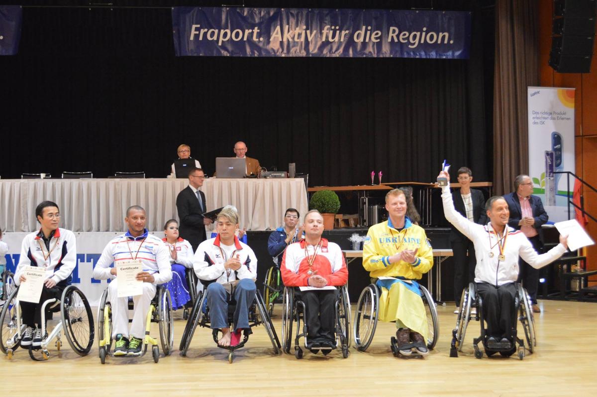 Five male wheelchair dancers on the podium
