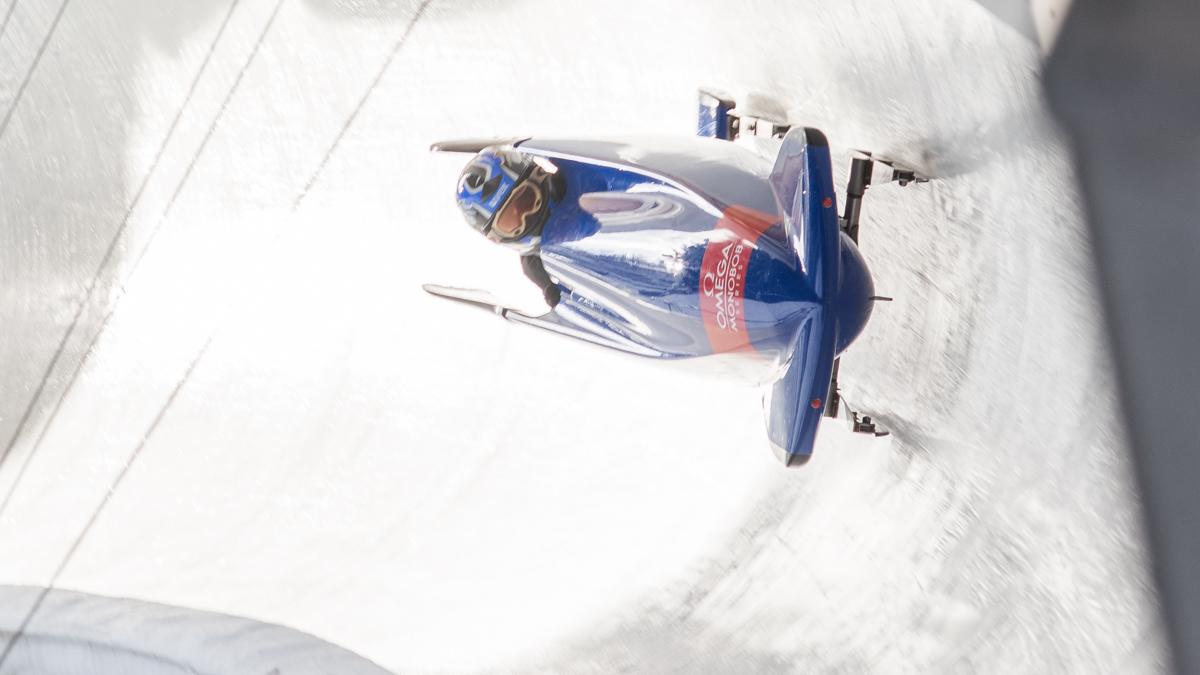 man in bobsleigh goes round bend
