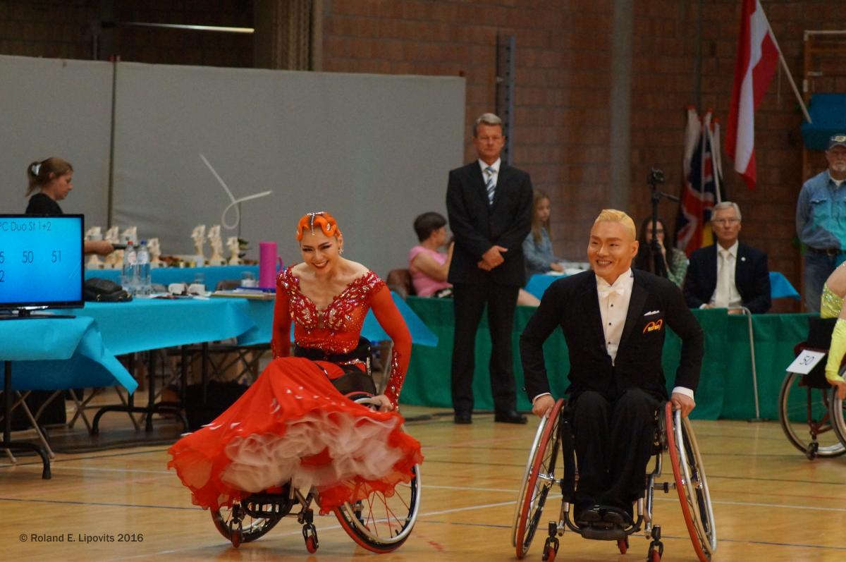 a male and female wheelchair dancer side by side